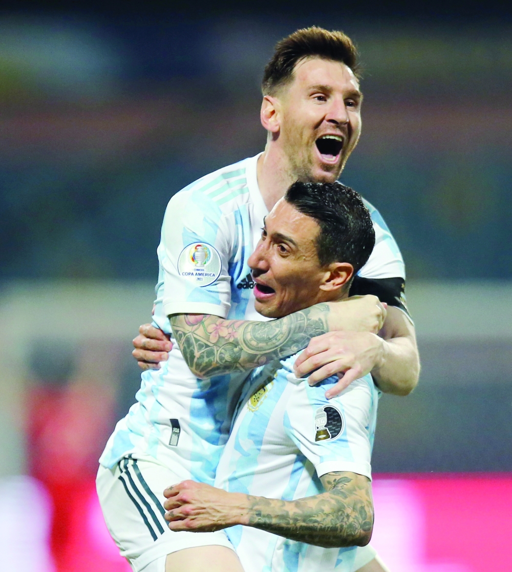 Argentina's Lionel Messi celebrates scoring their third goal with Angel Di Maria. -- Reuters