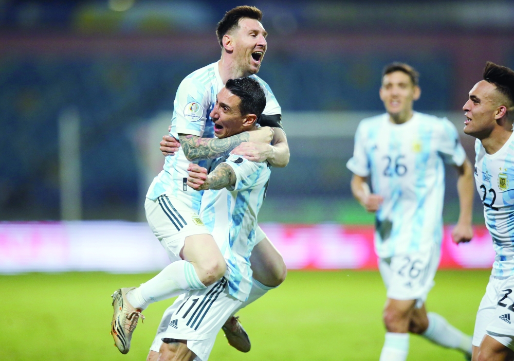 Argentina's Lionel Messi celebrates scoring their third goal with Angel Di Maria. -- Reuters