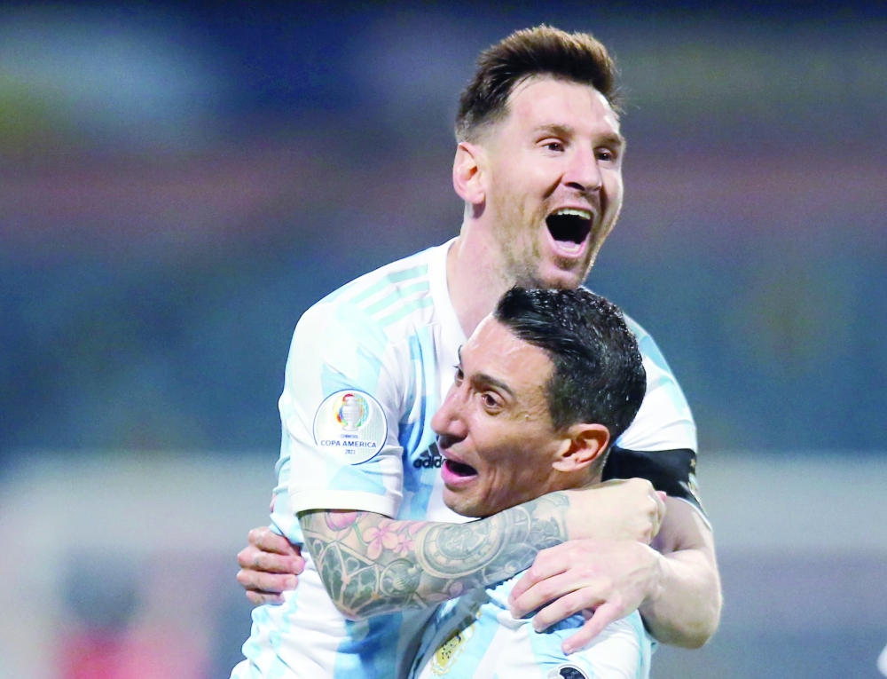Argentina's Lionel Messi celebrates scoring their third goal with Angel Di Maria. -- Reuters
