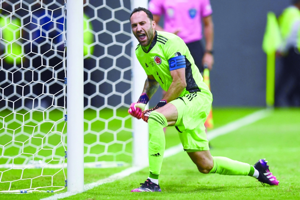 Colombia's goalkeeper David Ospina celebrates after stopping the penalty shot by Uruguay's Jose Maria Gimenez. -- AFP