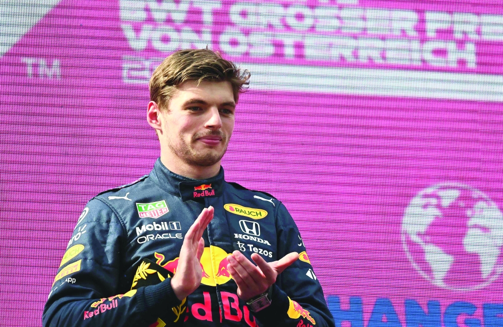 Red Bull's Dutch driver Max Verstappen celebrates on the podium after winning the Formula One Austrian Grand Prix at the Red Bull Ring race track in Spielberg, Austria, on July 4, 2021. / AFP / Joe Klamar

