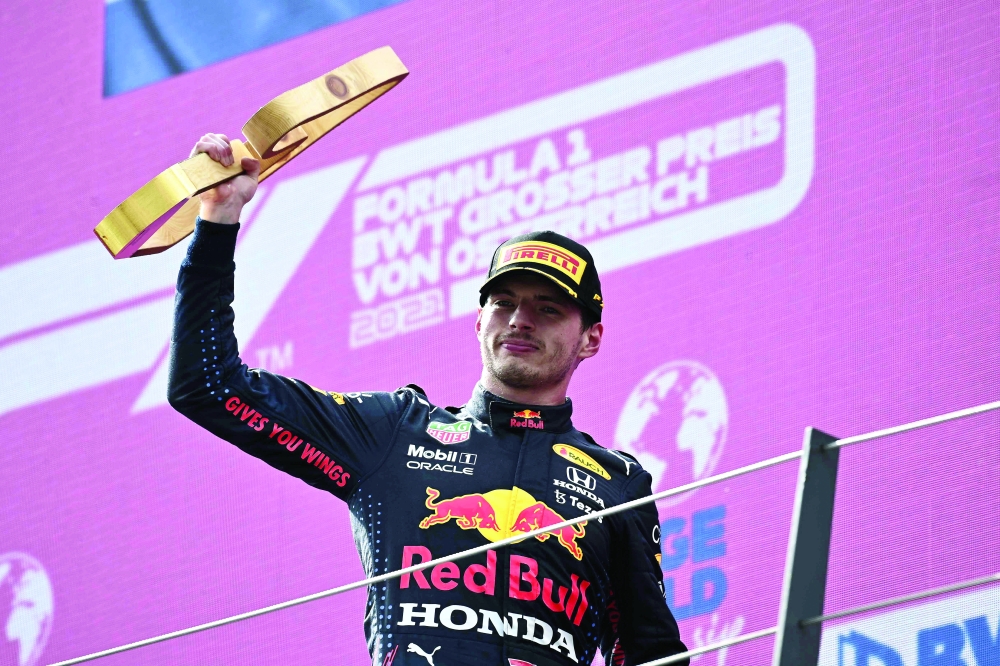 Winner Red Bull's Dutch driver Max Verstappen celebrates on the podium after the Formula One Austrian Grand Prix at the Red Bull Ring race track in Spielberg, Austria, on July 4, 2021. / AFP / POOL / CHRISTIAN BRUNA


