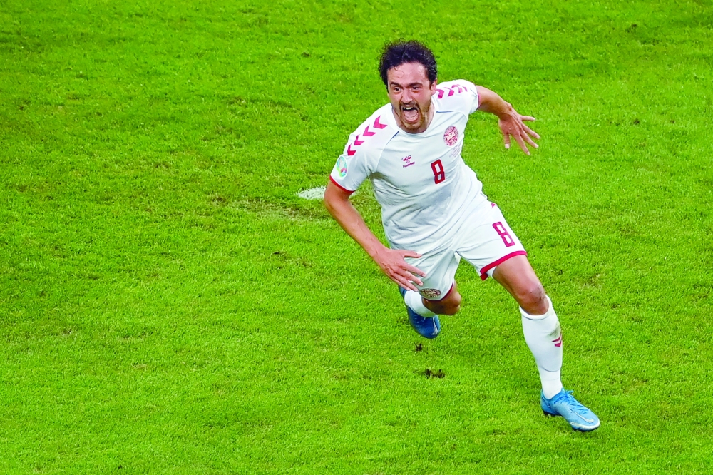 Denmark's midfielder Thomas Delaney celebrates scoring the opening goal. -- AFP