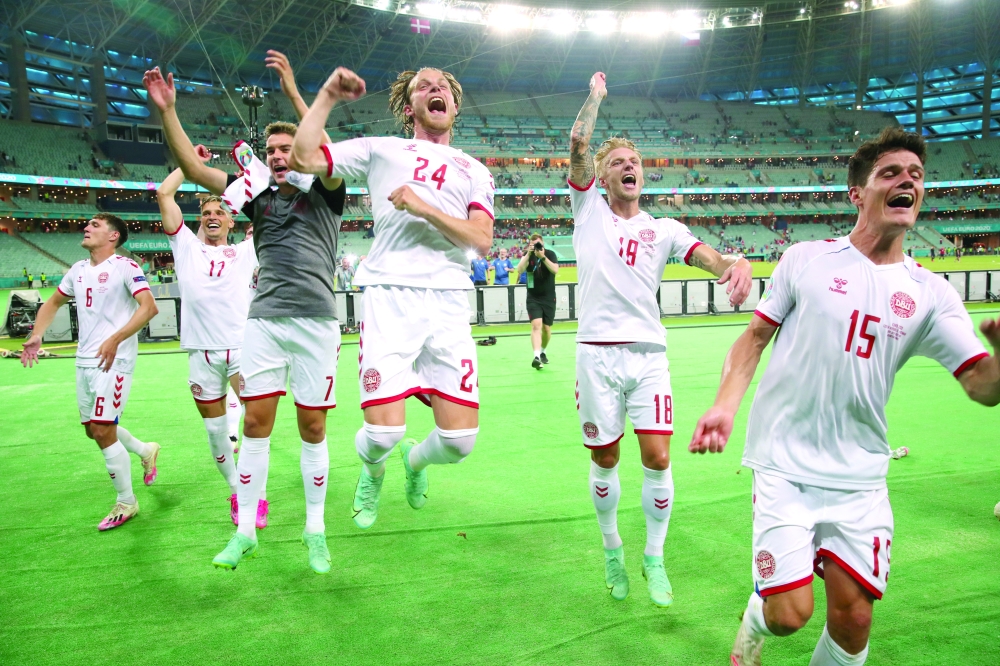 Denmark players celebrate after the match. -- Reuters