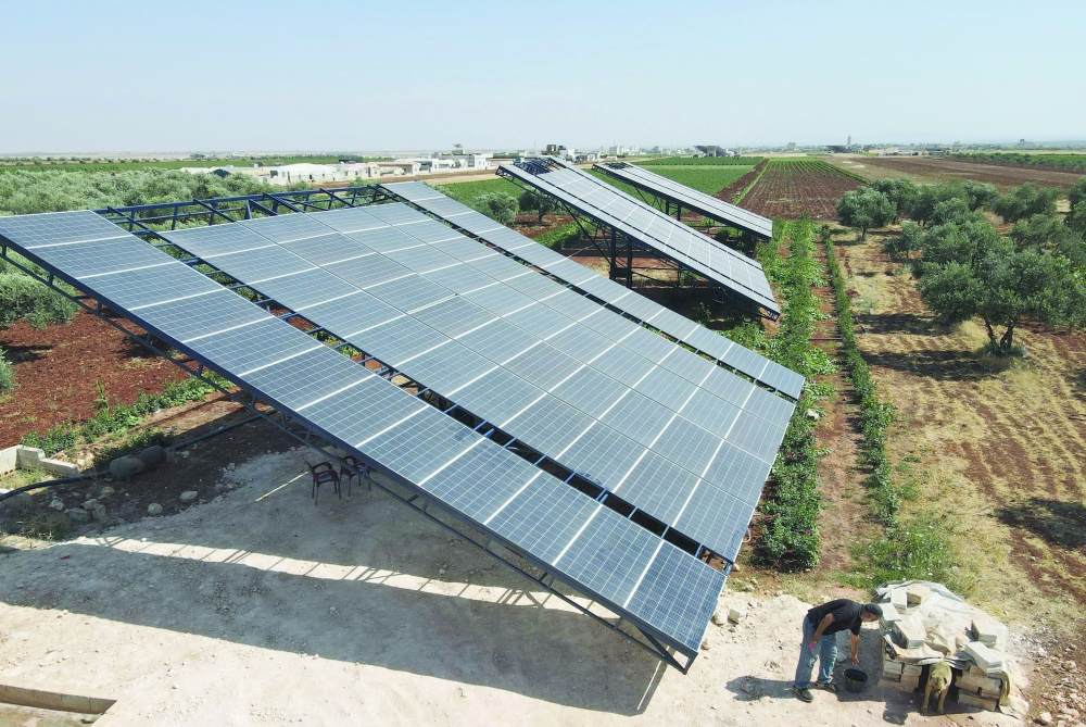 Solar panels are installed in agricultural fields, in the village of Killi, near Bab al-Hawa by the border with Turkey, in Syria's northwestern Idlib province. - AFP