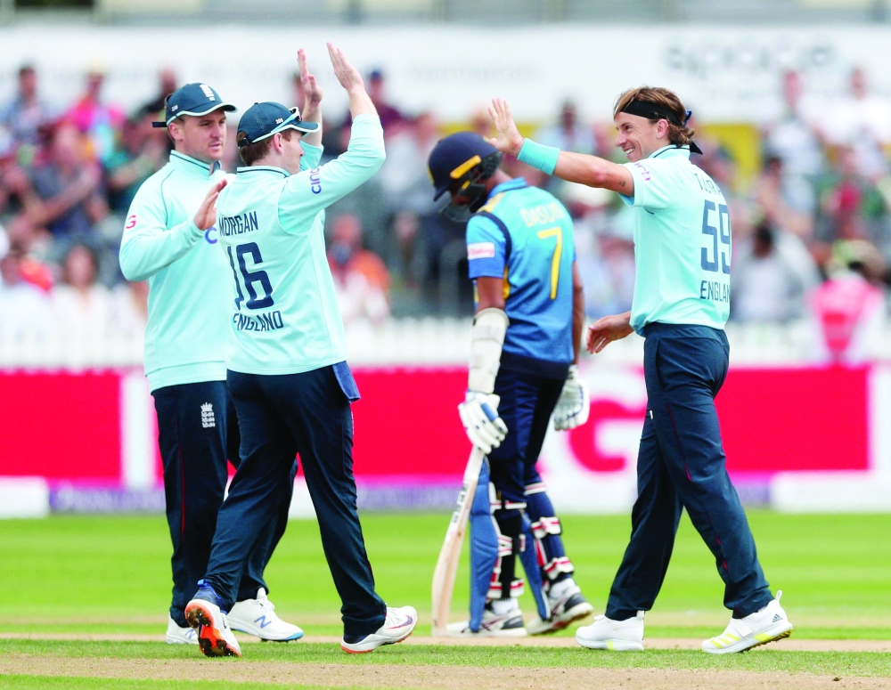Cricket - Third One Day International - England v Sri Lanka - Bristol County Ground, Bristol, Britain - July 4, 2021 England's Tom Curran celebrates with Eoin Morgan after taking the wicket of Sri Lanka's Wanindu Hasaranga Action Images via Reuters/Matthew Childs
