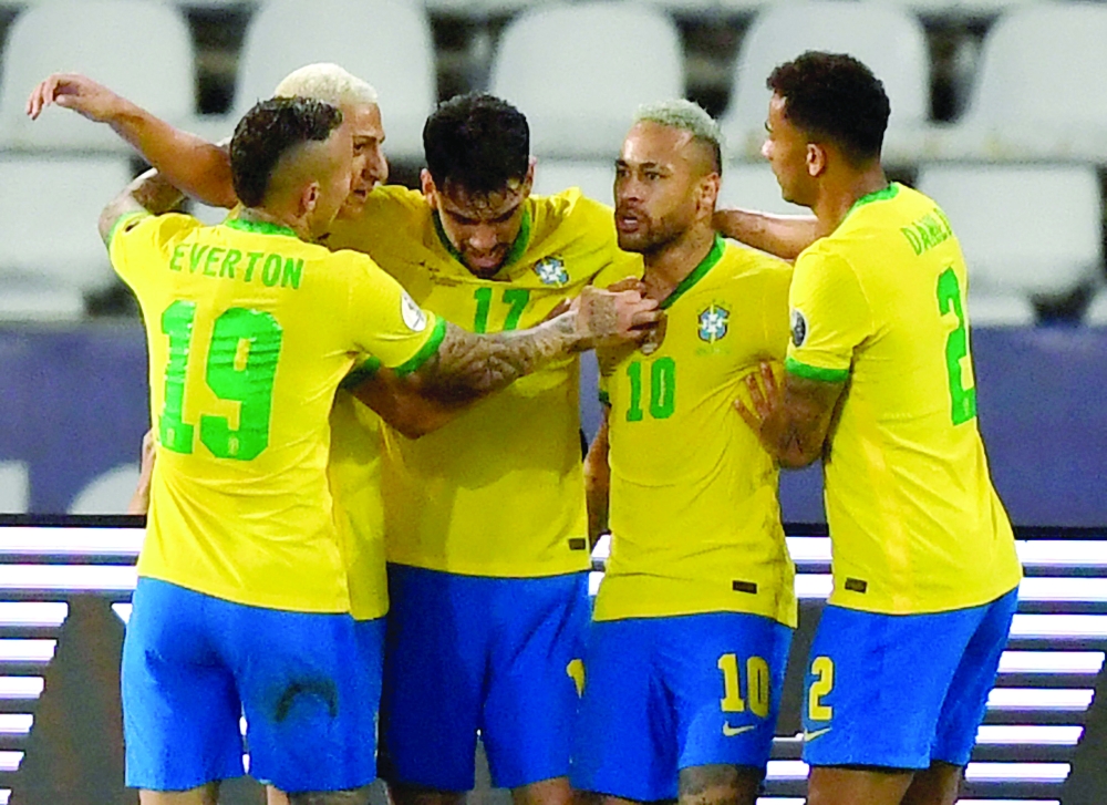 Brazil's Lucas Paqueta (C) celebrates with teammates after scoring against Peru. -- AFP