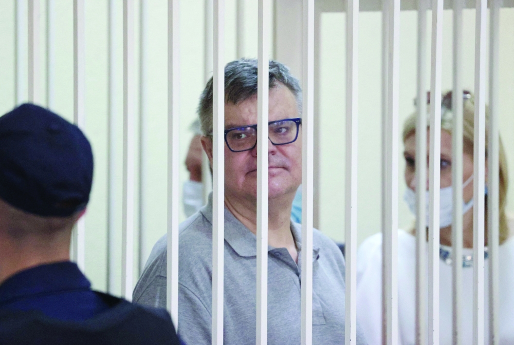 Opposition politician and banker Viktor Babaryko, charged with corruption and money laundering, stands inside a defendants' cage during his sentencing in Minsk on Tuesday. -- AFP