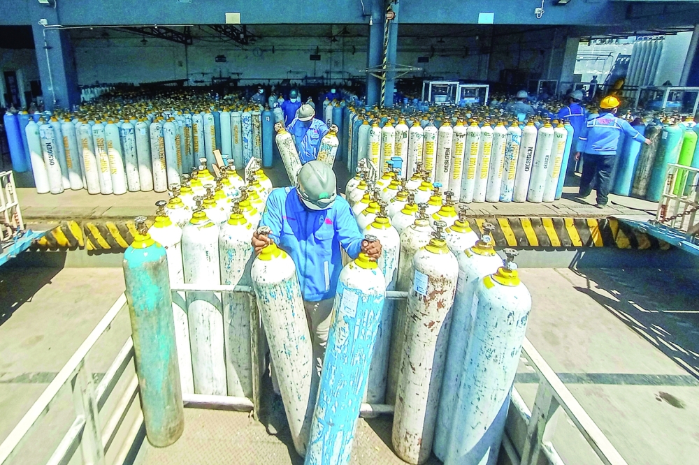 Workers for an oxygen supplies company prepare cylinders for distribution in Semarang, Central Java on Tuesday amid a surging demand for oxygen. - AFP 