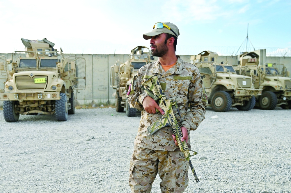 An Afghan policeman stands guard inside the Bagram US air base after all US and Nato troops left, some 70km north of Kabul. - AFP