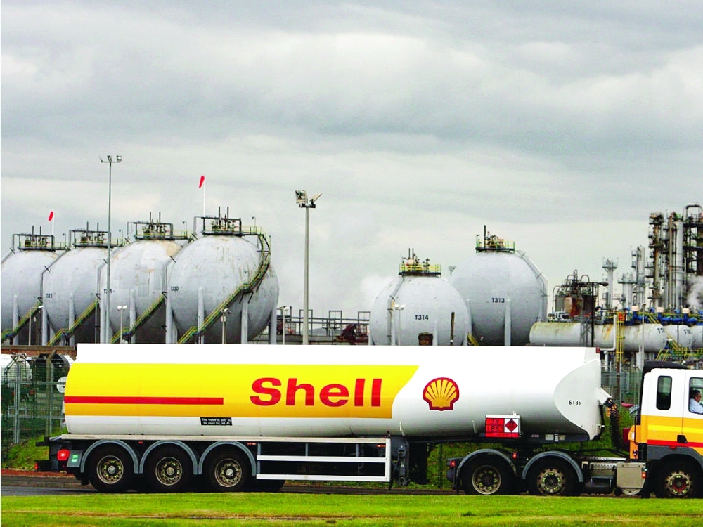 A shell oil delivery truck is parked outside an oil refinery plant in Houston, Texas. — Reuters