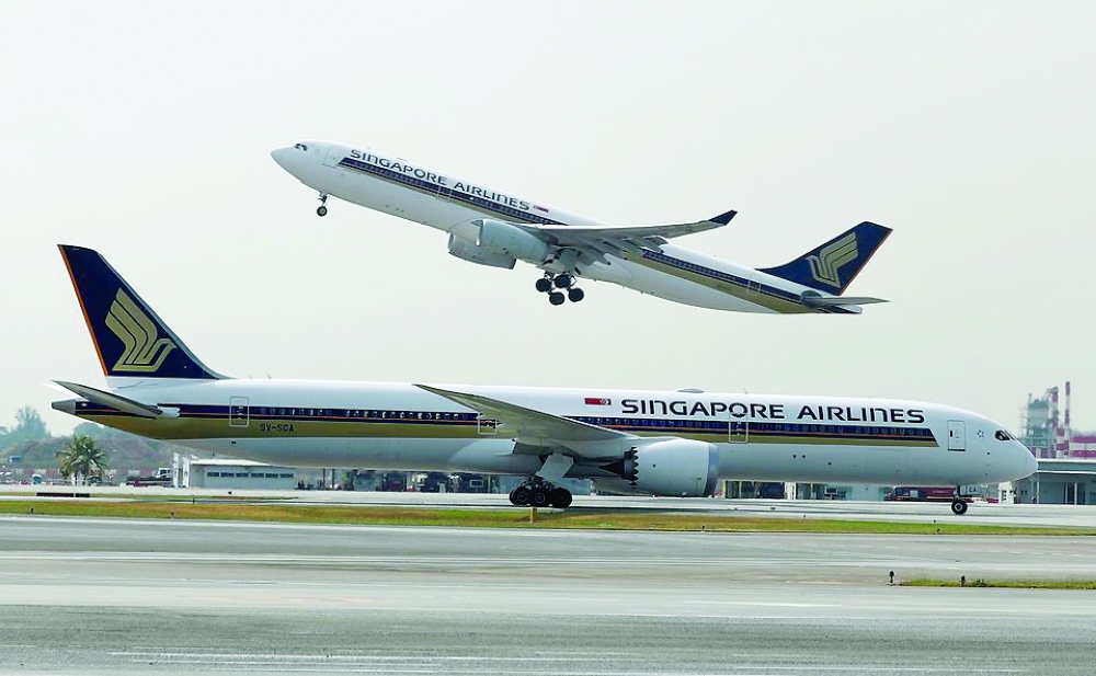 A Singapore Airlines Airbus A330-300 plane takes off behind a Boeing 787-10 Dreamliner at Changi Airport in Singapore. - Reuters File Photo

