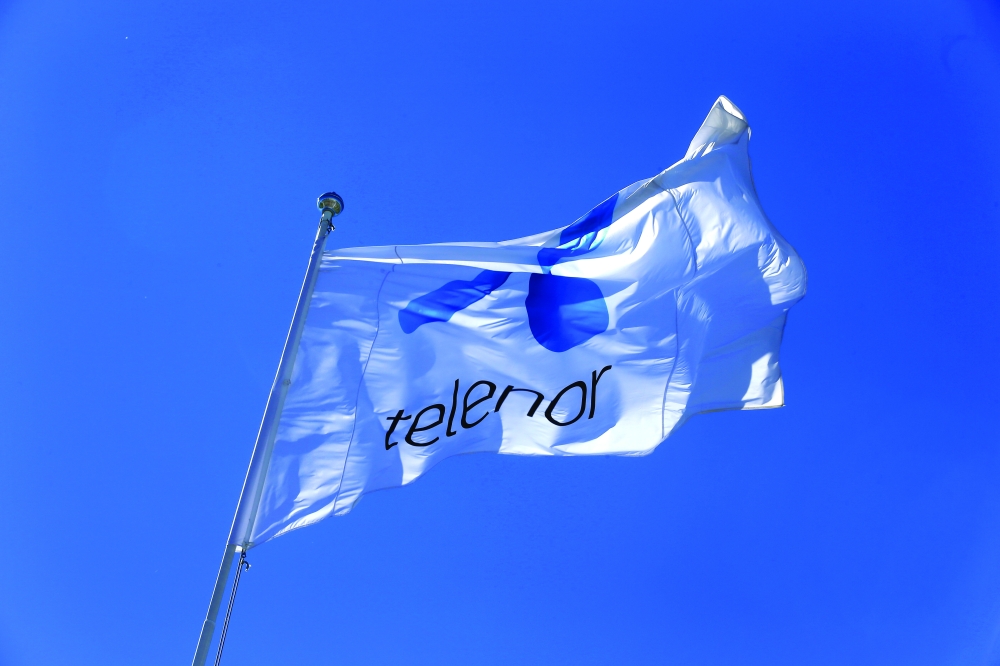 Telenor flag flutters next to the company's headquarters in Fornebu, Norway. - Reuters