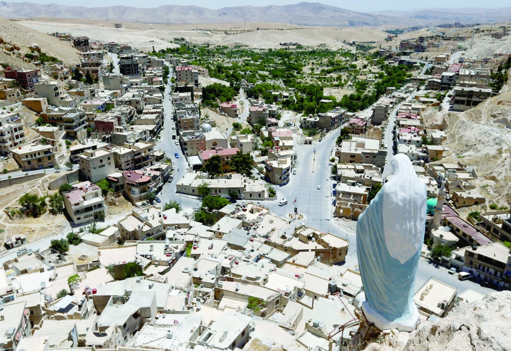 A statue of the Virgin Mary overlooks the village of Maalula, north of the Syrian capital Damascus. -- AFP
