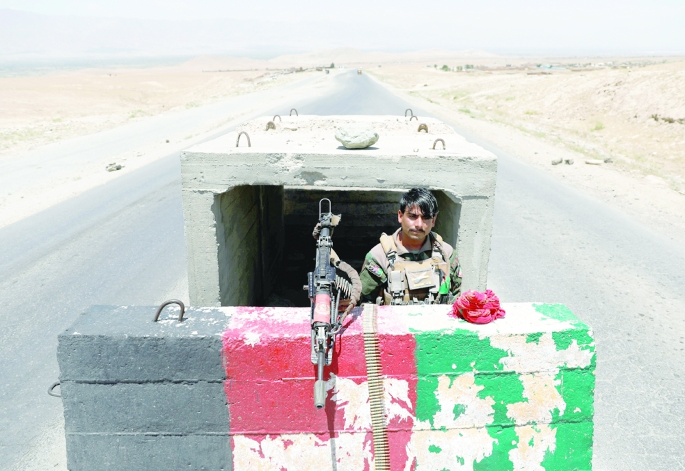 An Afghan National Army soldier stands guard at a checkpoint near Bagram US air base. -- Reuters