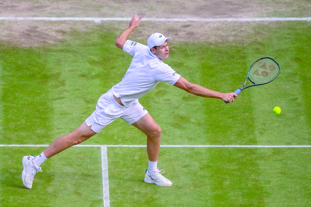 Poland's Hubert Hurkacz in action against Switzerland's Roger Federer. 