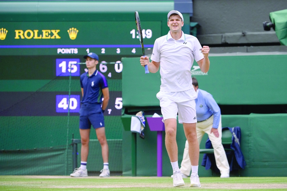 Poland's Hubert Hurkacz celebrates after beating Switzerland's Roger Federer.