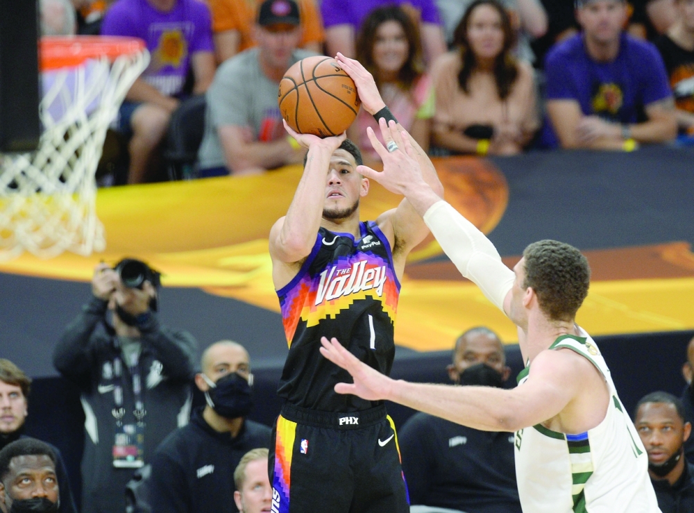 Phoenix Suns guard Devin Booker (1) shoots against Milwaukee Bucks center Brook Lopez (11). -- USA Today Sports
