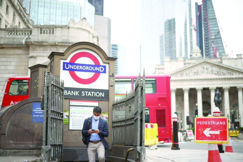 A person exits Bank underground station in the City of London financial district in London. - Reuters