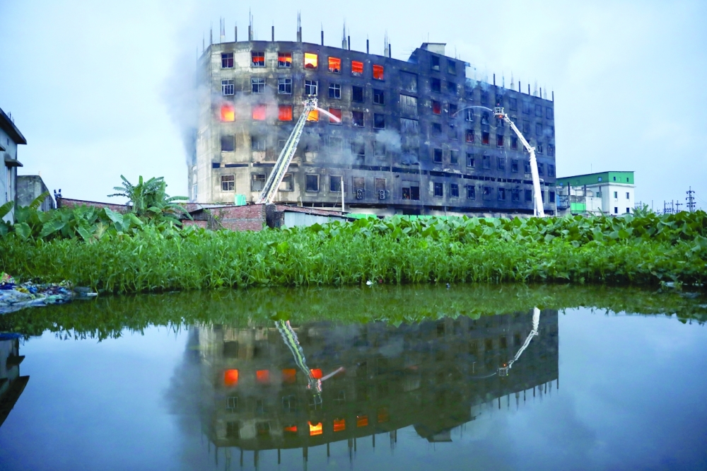 Flames rise the morning after a fire broke out at a factory named Hashem Foods Ltd in Rupganj of Narayanganj district, on the outskirts of Dhaka. - Reuters
