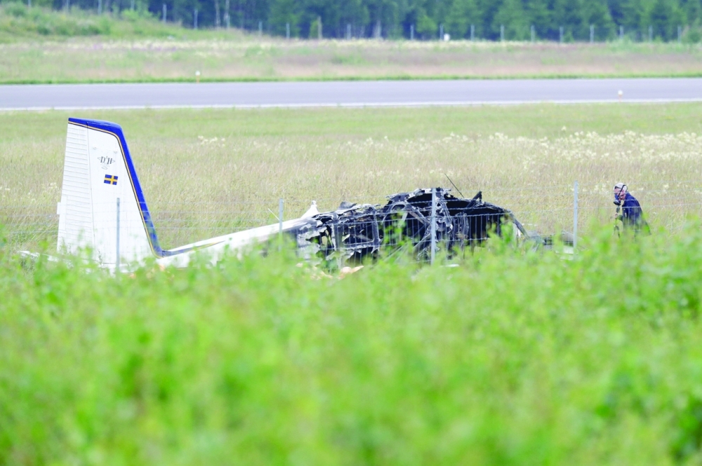 Police officers investigate the plane wreck outside Orebro Airport. - AFP