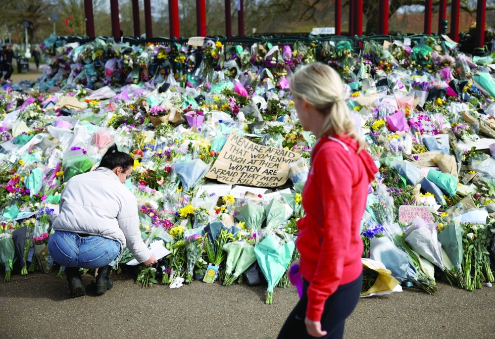 People observe a memorial site at the Clapham Common Bandstand, following the kidnapping and murder of Sarah Everard in London. - Reuters File Photo
