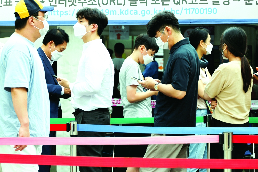 People wait in line for a coronavirus disease test at a testing site which is temporarily set up at a public health centre in Seoul. - Reuters 
