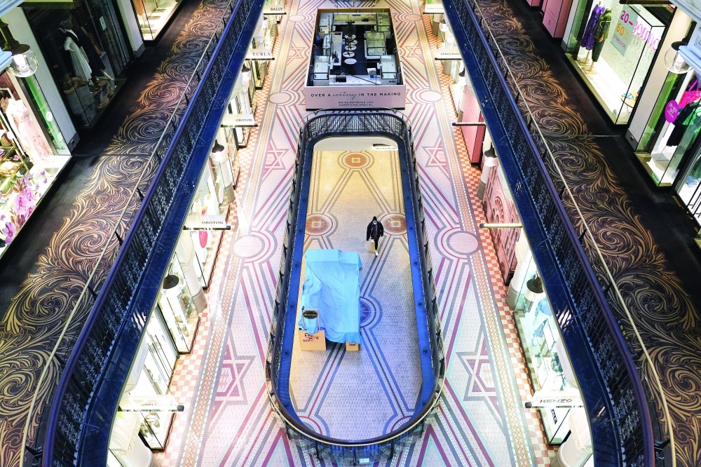 A person wearing a protective mask walks in a deserted shopping mall in the city centre during a lockdown to curb the spread of the coronavirus disease in Sydney. - Reuters 