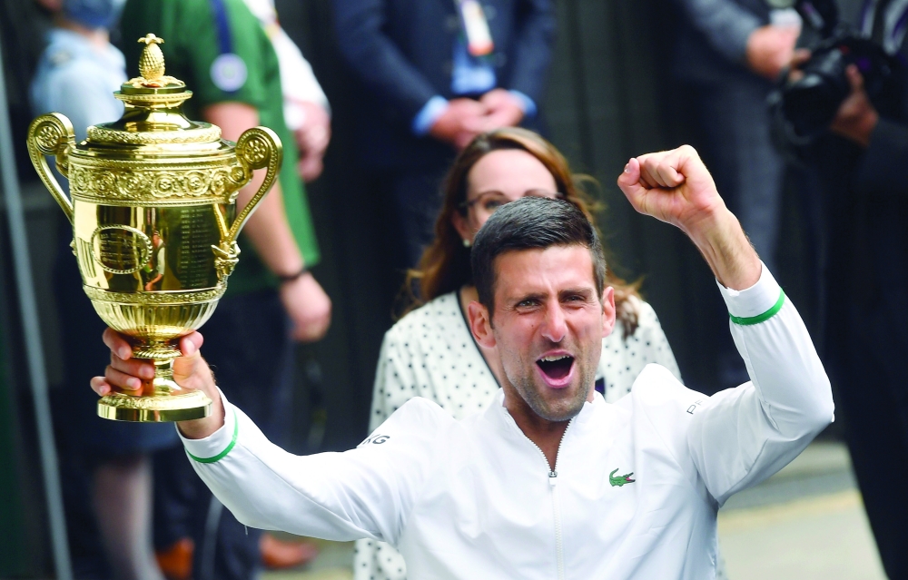 Serbia's Novak Djokovic celebrates with the trophy after winning his final match against Italy's Matteo Berrettini. --Reuters