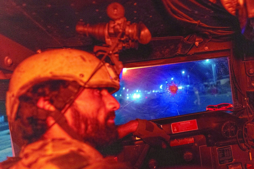 A member of the Afghan Special Forces drives a humvee during a combat mission against Taliban, in Kandahar province. -- Reuters