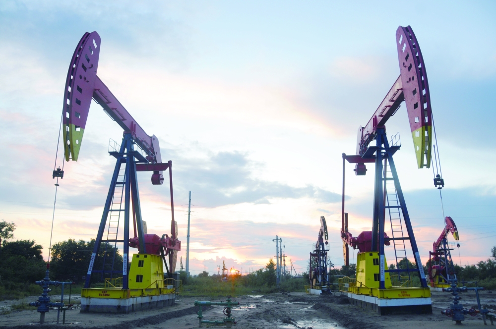 Pumpjacks are seen during sunset at the Daqing oil field in Heilongjiang, China. — Reuters