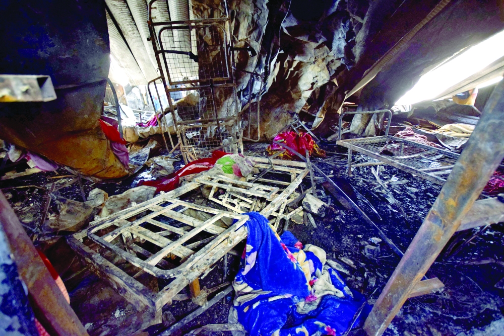 Blankets are strewn among burnt hospital beds at the ravaged coronavirus isolation ward of Al Hussain hospital in Nassiriya, on Tuesday. - AFP 