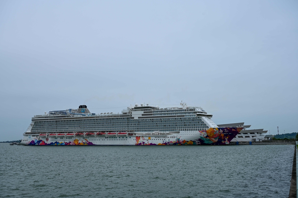 Dream Cruises' World Dream cruise ship is docked at the Marina Bay Cruise Centre in Singapore on July 14, 2021, after it returned to the city-state following a passenger's positive test for the Covid-19 coronavirus. 