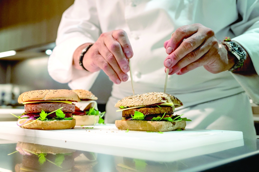 Chef Nicolas Maire prepares a vegetal burger. - AFP