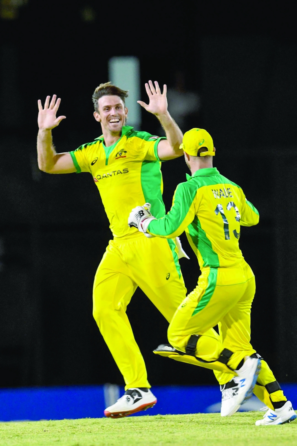 Mitchell Marsh (L) of Australia celebrates the dismissal of Lendl Simmons of West Indies. -- AFP
