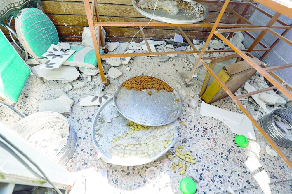 A view of unfinished trays of traditional desserts and pastries lying amidst debris on the floor of a room in a house that was hit by reported Syrian regime artillery shelling, in the village of Iblin in the Jabal al-Zawiya region of Idlib province. -- AFP