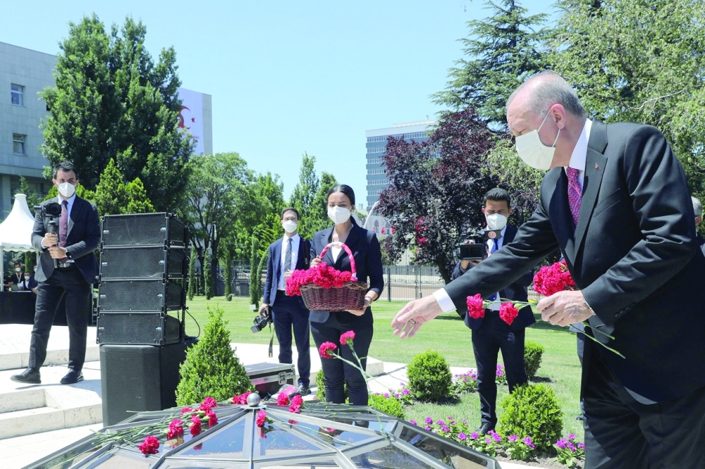 Turkish President Recep Tayyip Erdogan lays flowers during a commemorative ceremony marking the fifth anniversary of failed coup at the Turkish Grand National Assembly in Ankara on Thursday. -- AFP