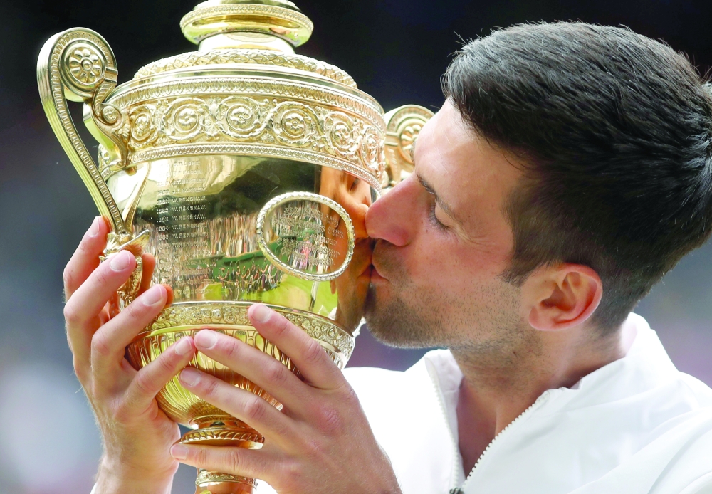 Serbia's Novak Djokovic celebrates with the Wimbledon trophy. -- Reuters