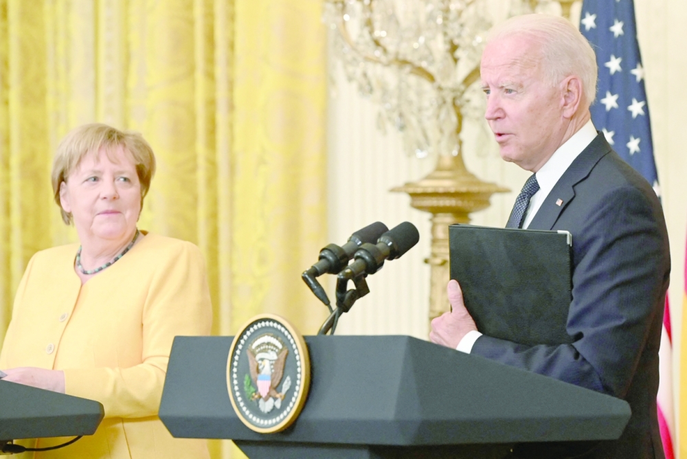 US President Joe Biden and German Chancellor Angela Merkel hold a joint press conference at the White House in Washington, DC. - AFP