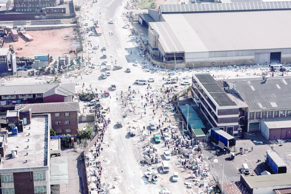 Aerial view shows rescue personnel working on site after a fire gutted the Springfiled Park, at Mobeni, south of Durban. - AFP