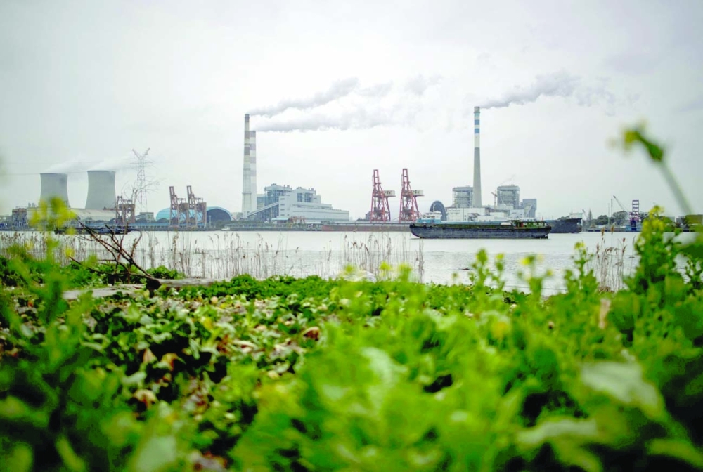 Huangpu river and the Wujing Coal-Electricity Power Station in Shanghai. - AFP File Photo