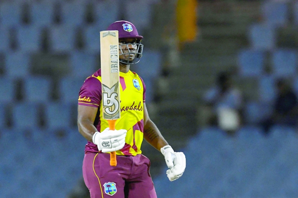 Evin Lewis of West Indies celebrates his half century. -- AFP