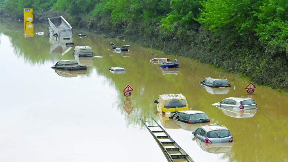 Submerged cars and other vehicles are seen on the federal highway B265 in Erftstadt, western Germany, on Saturday. - AFP