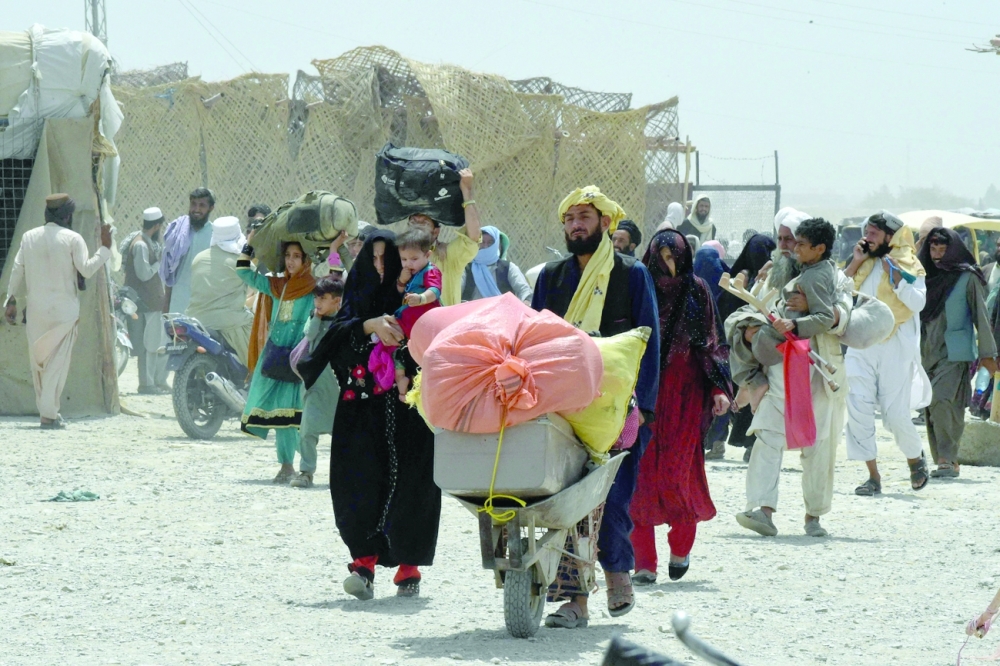 People walk towards a border crossing point in Pakistan's border town of Chaman on Saturday, after Pakistan partially reopened its southern crossing with Afghanistan. - AFP 