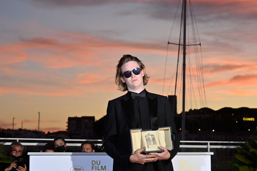 Caleb Landry Jones poses with his trophy after he won the Best Actor Prize 