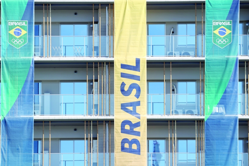 Signs from the Brazil Olympic team hang on the apartment building hosting Olympics participants at the Athletes Village, where two athletes have tested positive for COVID-19. -- Reuters