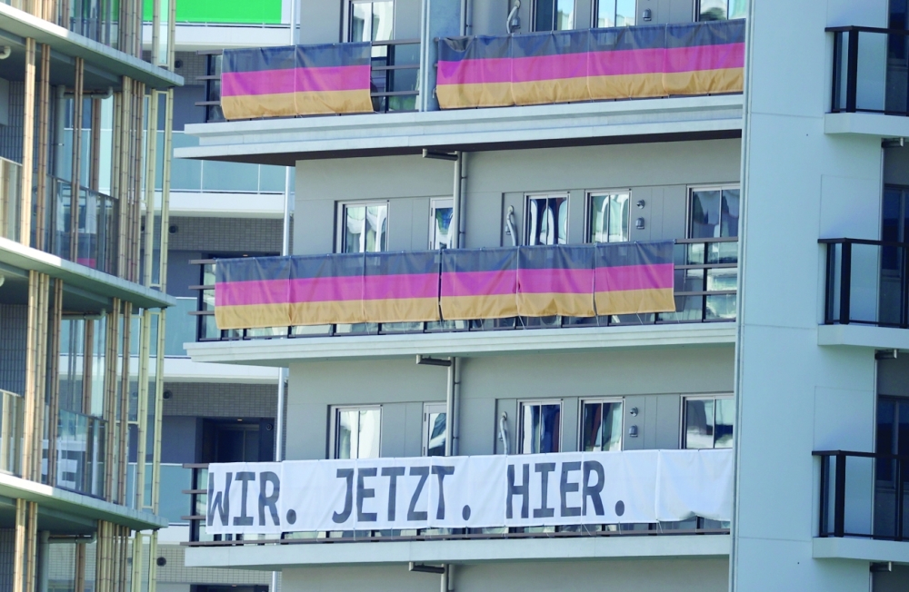 Signs from the Germany Olympic team hang on the apartment building hosting Olympics participants. -- Reuters