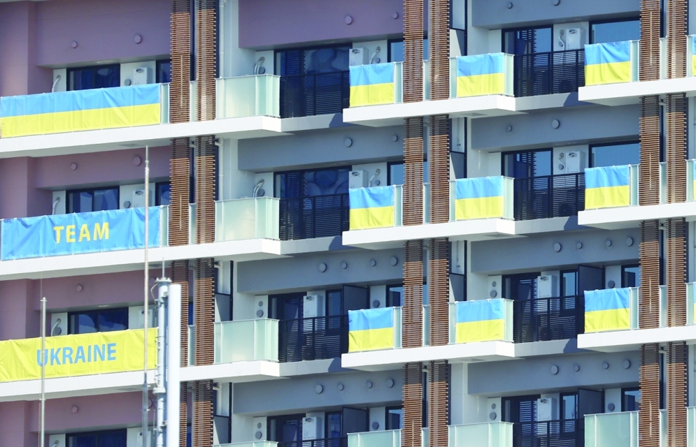 Flags from the Ukraine Olympic team hang on the apartment building hosting Olympics participants at the Athletes Village. -- Reuters
