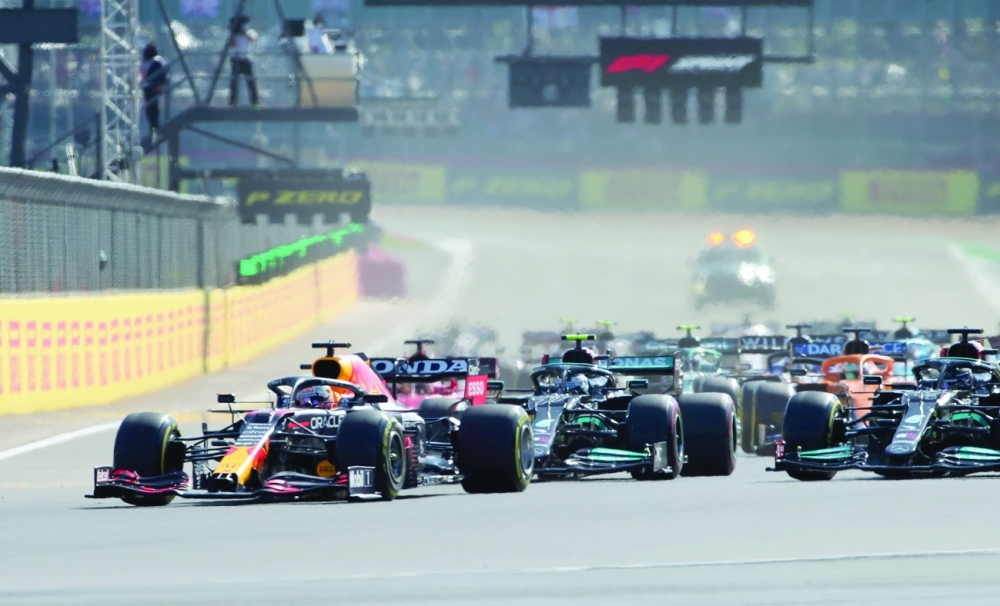 Red Bull's Max Verstappen leads into the first corner at the start of sprint qualifying. -- Reuters