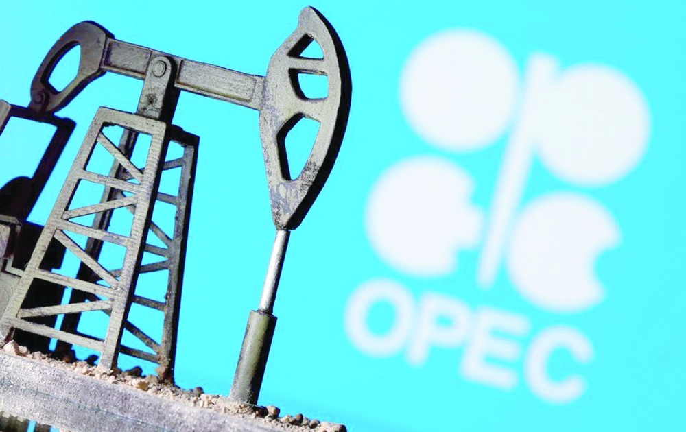 A 3D printed oil pump jack is seen in front of displayed Opec logo in this illustration picture. — Reuters